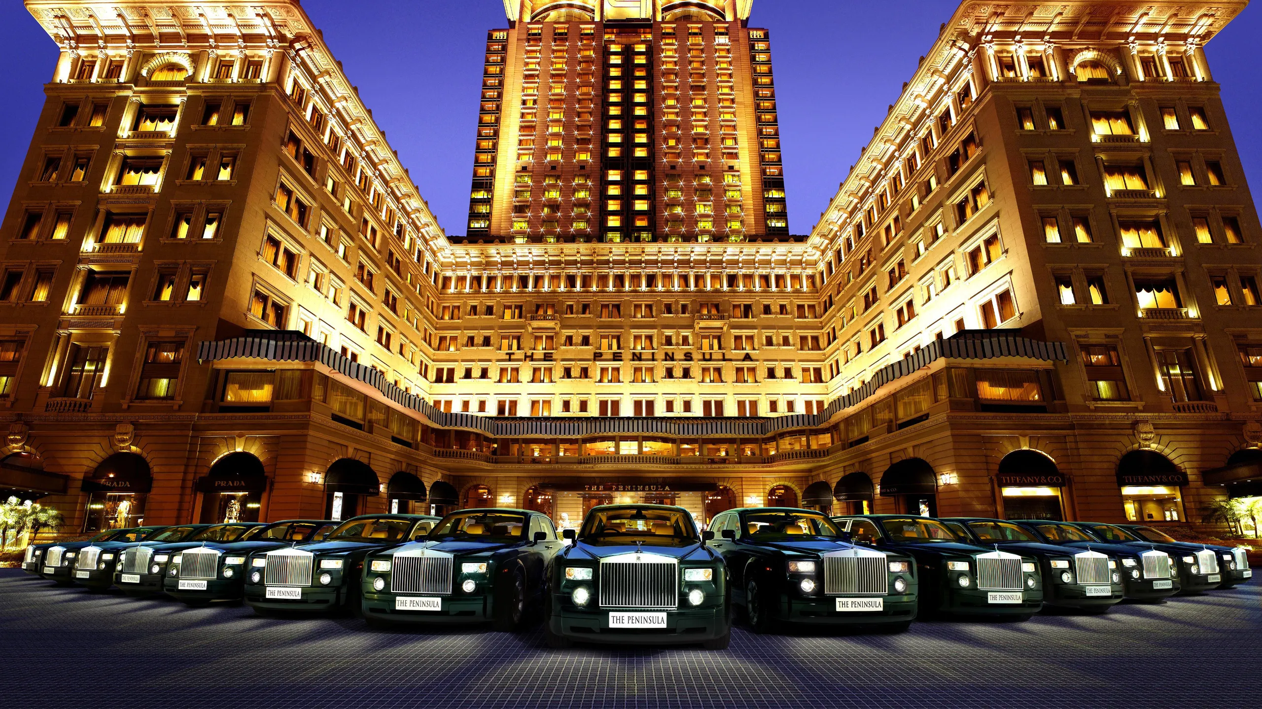 Ultra-realistic luxury black Mercedes S-Class parked at a five-star hotel entrance, elegant marble driveway, warm golden lighting, grand chandelier ambiance